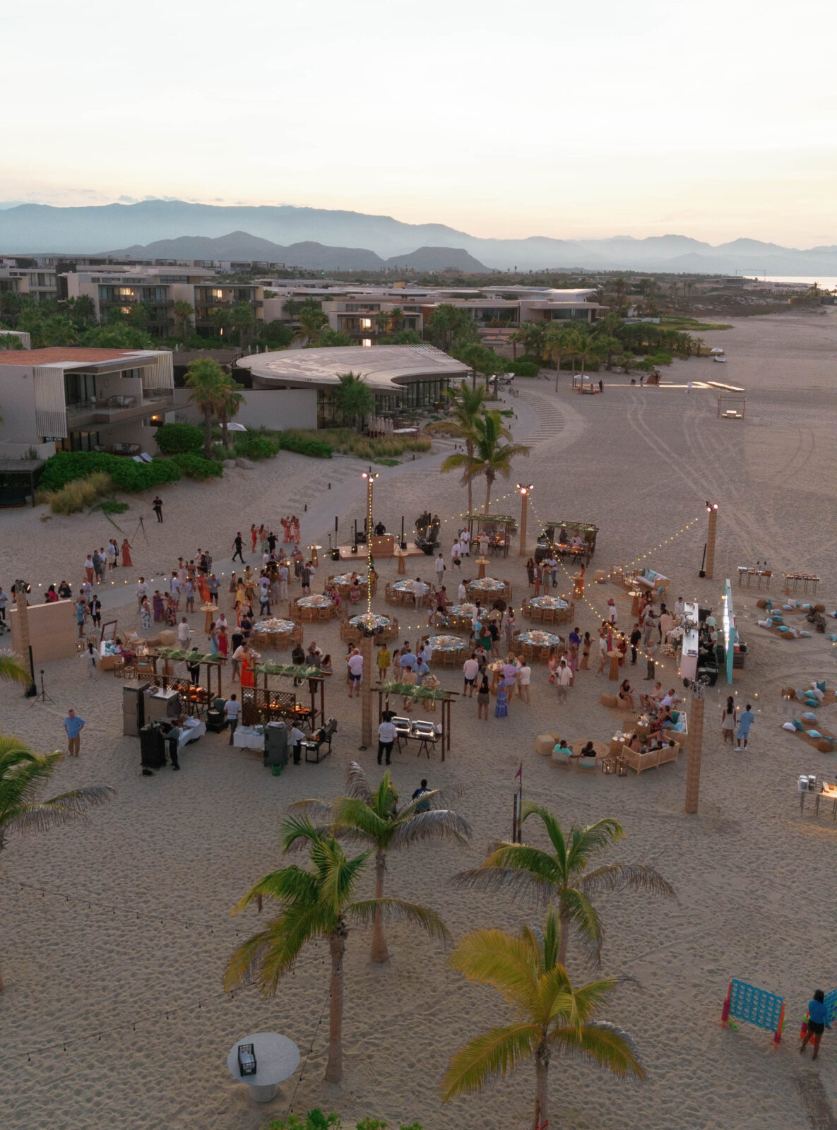 Romantic wedding dinner on the sand – A candlelit dining setup on the beach, featuring elegant place settings and soft waves in the distance.