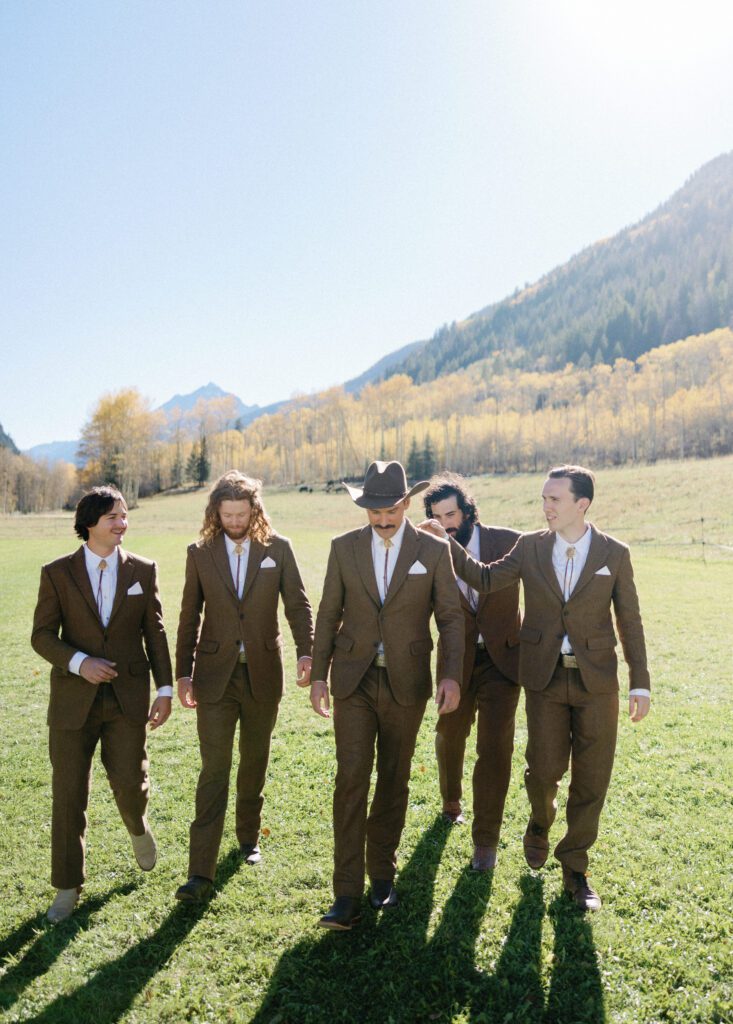 groom and groomsmen with a mountain view