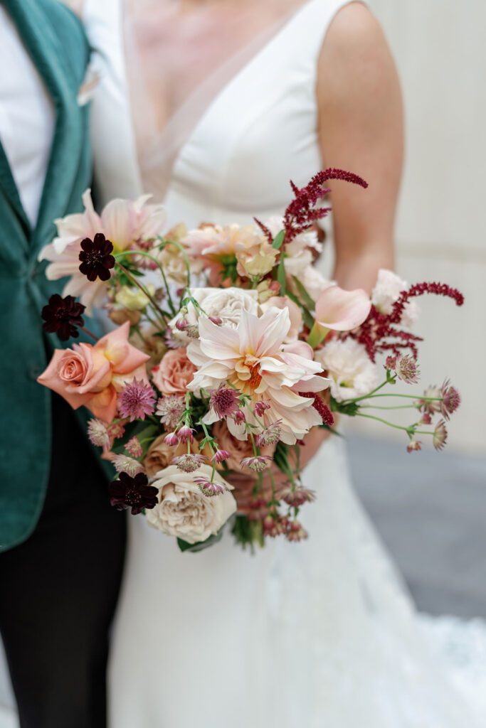 Bride holding blush floral bouquet