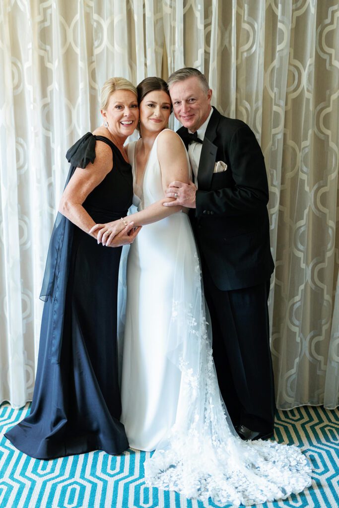 Bride with parents before ceremony