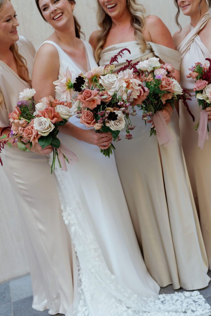 Bridesmaids with peach and mauve bouquets