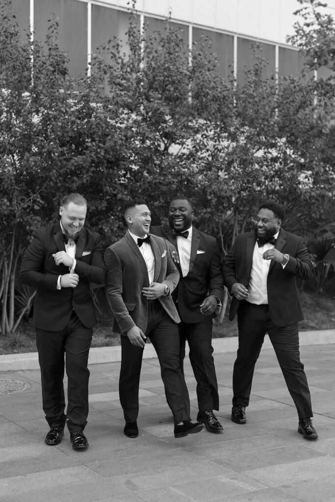 Groom and his groomsmen looking sharp in coordinating attire, capturing a moment of camaraderie and excitement before the ceremony.