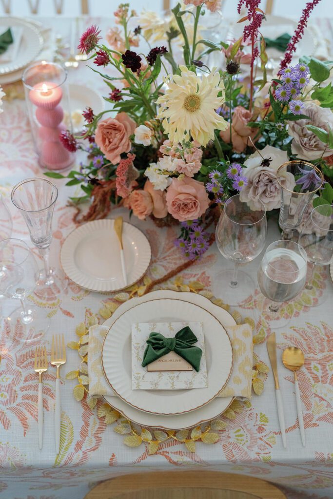 Floral filled tablescape with gold accents ribbed candles and unique florals