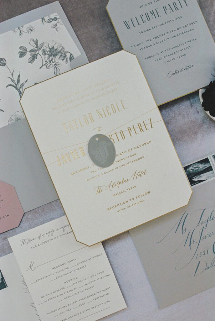 Gold-edged wedding invitation suite with floral liner