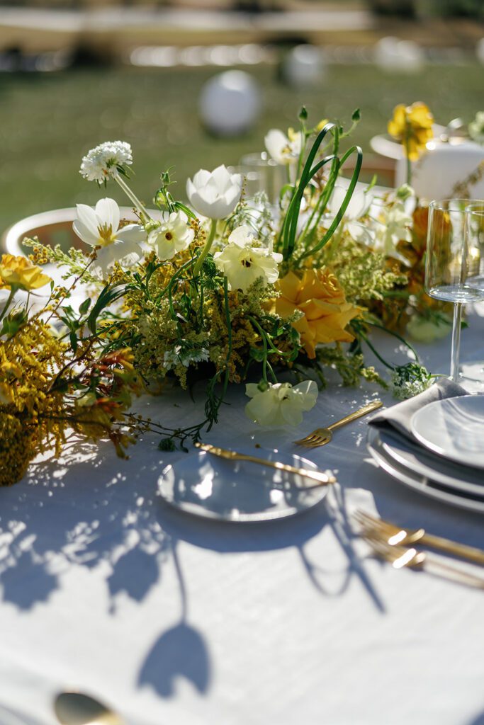 Greenery-filled dining area styled for Visa × Ramp’s Tasting on the Turf event.