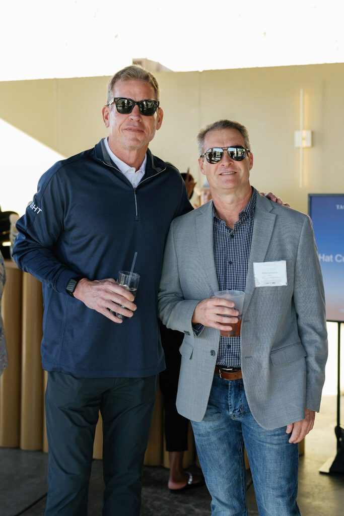 Troy Aikman posing with guest