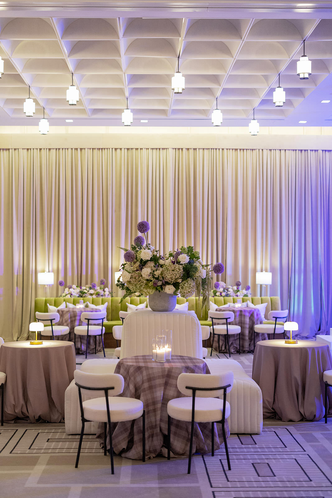 Refined lounge seating with mauve tables, plaid linens, and lush floral centerpiece at The Crescent Fort Worth corporate event designed by Alexa Kay Events.
