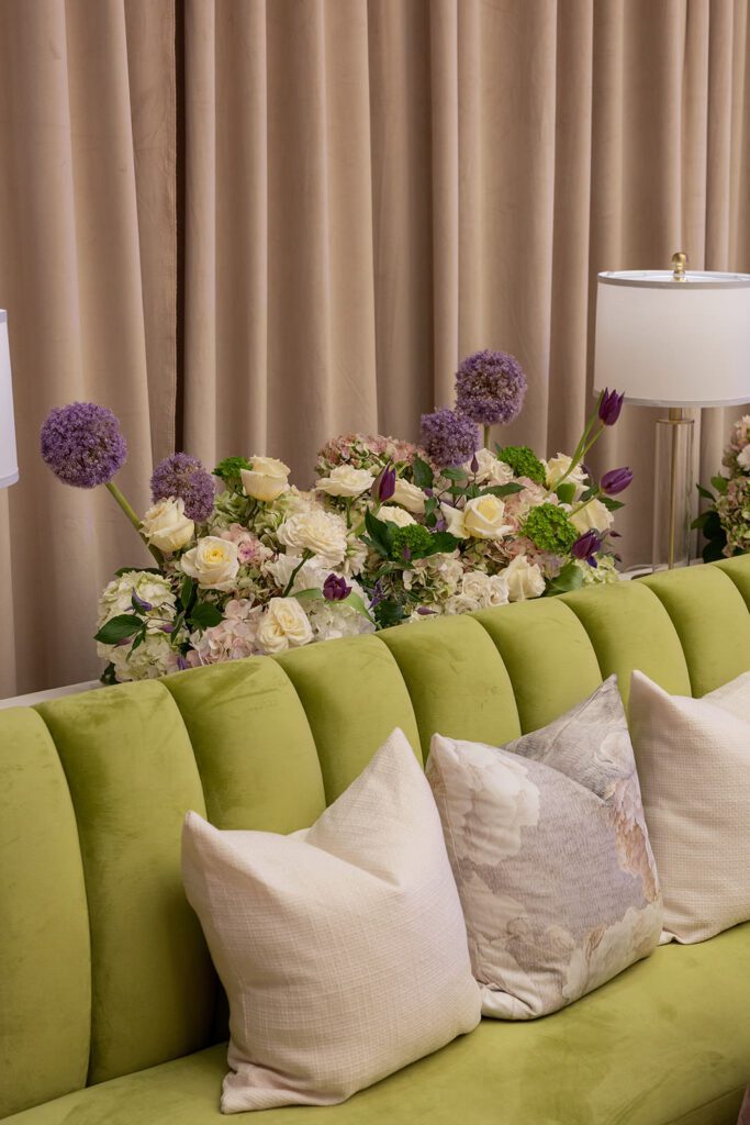 Corporate event reception space layered with lilac linens and candlelight.