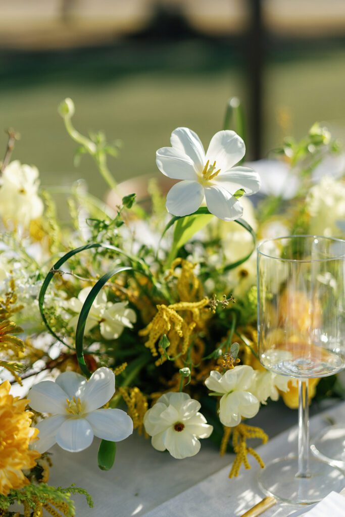 Bright citrus-toned floral centerpiece by Scout Floral for Dallas corporate event design.