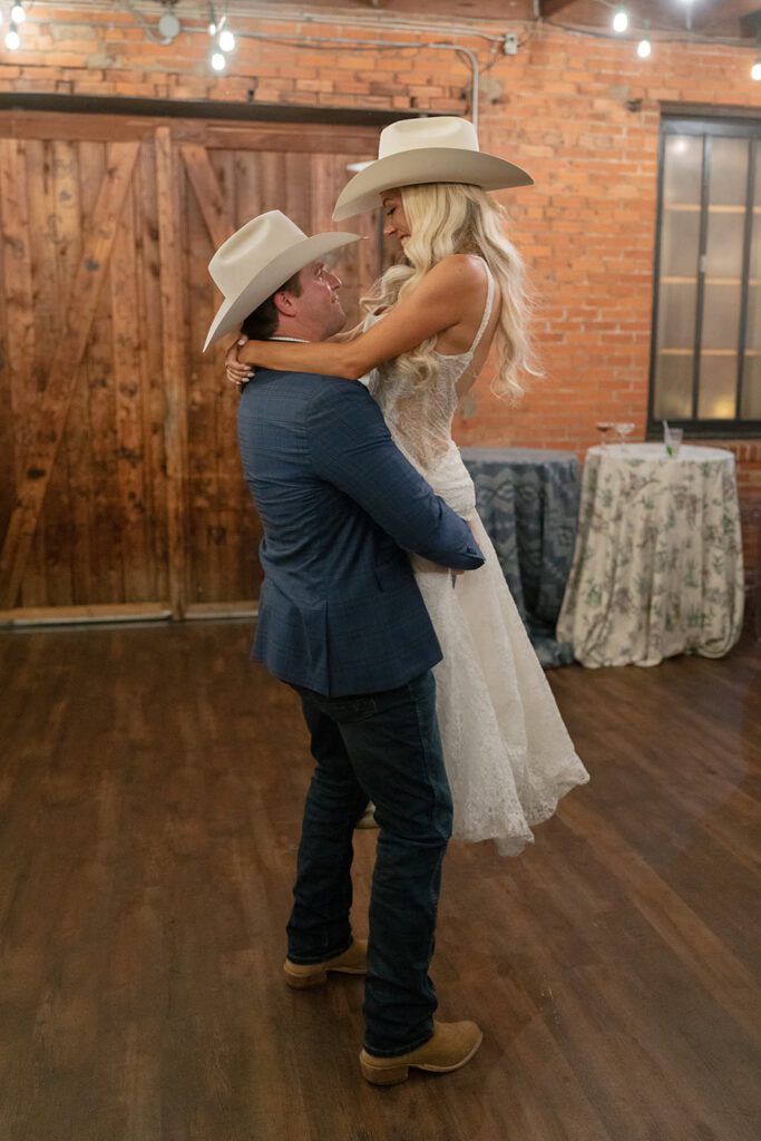 Nighttime portraits of the couple outside Lonesome Dove under glowing lights.