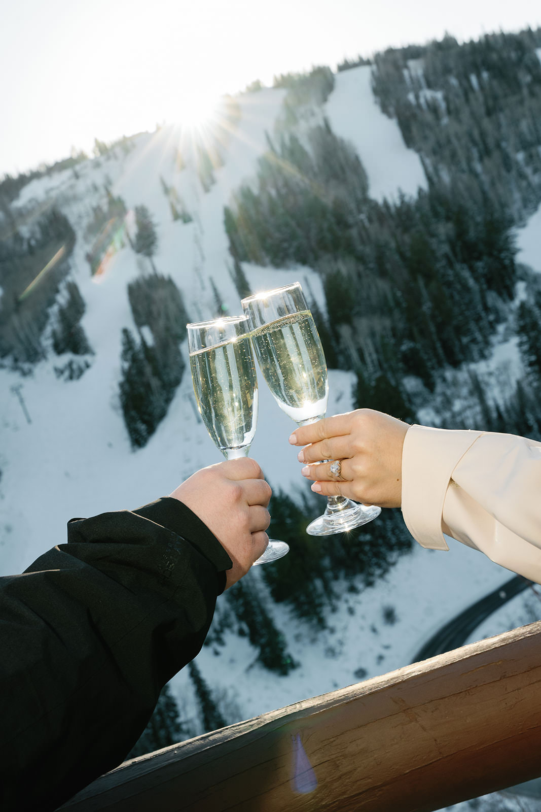 Couple celebrating engagement with champagne at St. Regis Deer Valley