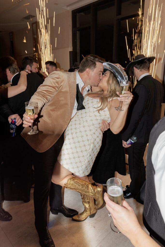 Bride in party dress and boots during New Year’s Eve wedding reception